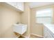 Laundry room with utility sink and cabinets at 3215 Lake View Blvd, Port Charlotte, FL 33948