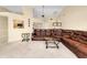 Spacious living room featuring a large brown leather sectional sofa at 3215 Lake View Blvd, Port Charlotte, FL 33948