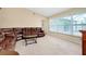 Spacious living room with large windows and a comfortable sectional sofa at 3215 Lake View Blvd, Port Charlotte, FL 33948