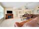 Living room with fireplace, large sectional sofa, and ample natural light at 3215 Lake View Blvd, Port Charlotte, FL 33948