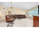 Relaxing living room with a large sectional sofa and ample natural light at 3215 Lake View Blvd, Port Charlotte, FL 33948