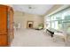 Bright living room with bay window, carpeted floor, and ample natural light at 3215 Lake View Blvd, Port Charlotte, FL 33948
