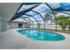 Inviting screened pool area with large patio great for relaxing and entertaining at 3215 Lake View Blvd, Port Charlotte, FL 33948