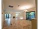 Open dining room with views to living room and patio at 4802 Kestral Park Cir # 22, Sarasota, FL 34231