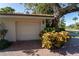 Garage with brick pavers and landscaping at 4802 Kestral Park Cir # 22, Sarasota, FL 34231