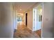 Long hallway with tile floors and doors to rooms at 4802 Kestral Park Cir # 22, Sarasota, FL 34231