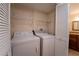 Bright laundry room with washer and dryer included, and extra shelving at 4802 Kestral Park Cir # 22, Sarasota, FL 34231