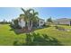 Spacious backyard with lush lawn, patio, and palm trees at 5060 Lake Overlook Ave, Bradenton, FL 34208