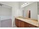Bathroom with granite countertop, wood cabinets, and a large mirror at 5060 Lake Overlook Ave, Bradenton, FL 34208