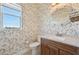 Powder room with floral wallpaper and wood vanity at 5060 Lake Overlook Ave, Bradenton, FL 34208