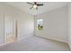 Bedroom with gray carpeting and a ceiling fan at 5060 Lake Overlook Ave, Bradenton, FL 34208