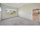 Large bedroom with grey carpet and kitchen view at 5060 Lake Overlook Ave, Bradenton, FL 34208