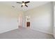 Bedroom with gray carpeting and ceiling fan; en-suite bathroom at 5060 Lake Overlook Ave, Bradenton, FL 34208