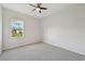Bedroom featuring gray carpeting and a ceiling fan at 5060 Lake Overlook Ave, Bradenton, FL 34208