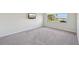 Spacious bedroom with grey carpet and water view at 5060 Lake Overlook Ave, Bradenton, FL 34208