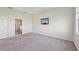 Bedroom with grey carpet, bathroom access and water view at 5060 Lake Overlook Ave, Bradenton, FL 34208