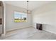 Dining room with modern chandelier and wood-look floors at 5060 Lake Overlook Ave, Bradenton, FL 34208