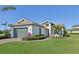 Single-story house with a two-car garage and well-manicured lawn at 5060 Lake Overlook Ave, Bradenton, FL 34208