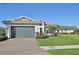 Charming one-story home with lush lawn, brick driveway, manicured landscaping and a two-car garage at 5060 Lake Overlook Ave, Bradenton, FL 34208