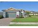 Charming one-story home with lush lawn, brick driveway, manicured landscaping and a two-car garage at 5060 Lake Overlook Ave, Bradenton, FL 34208