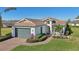 Front view of a single-Gathering home with a two-car garage at 5060 Lake Overlook Ave, Bradenton, FL 34208