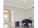 Spacious living area featuring hardwood floors, a grand piano, and an arched entryway at 5060 Lake Overlook Ave, Bradenton, FL 34208