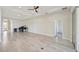 Large living room with hardwood floors and ceiling fan, offering access to other rooms at 5060 Lake Overlook Ave, Bradenton, FL 34208