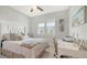 Bright bedroom with a comfortable bed, window shutters, and a workspace at 5252 Willow Lake Ct, Sarasota, FL 34233