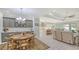 Open concept dining room and kitchen with gray cabinetry and an island at 5252 Willow Lake Ct, Sarasota, FL 34233