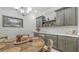 Rustic round dining table with gray cabinetry and wine rack at 5252 Willow Lake Ct, Sarasota, FL 34233