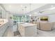 Open concept kitchen and living area with white cabinets and a large island at 5252 Willow Lake Ct, Sarasota, FL 34233