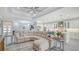 Open living room showcasing a large sectional sofa and access to the kitchen at 5252 Willow Lake Ct, Sarasota, FL 34233