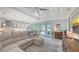 Living room with sectional sofa, large TV, and access to backyard at 5252 Willow Lake Ct, Sarasota, FL 34233