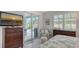 Main bedroom with sliding door access to the pool area at 5252 Willow Lake Ct, Sarasota, FL 34233