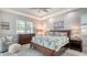King-size bed, wood dresser, and plenty of natural light in this main bedroom at 5252 Willow Lake Ct, Sarasota, FL 34233
