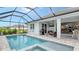 Inviting screened pool and spa with a spacious patio area at 5252 Willow Lake Ct, Sarasota, FL 34233