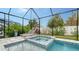 Relaxing pool and spa area with covered patio and lounge chairs at 5252 Willow Lake Ct, Sarasota, FL 34233