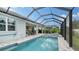 Relaxing screened pool and spa with grey tile deck at 5252 Willow Lake Ct, Sarasota, FL 34233