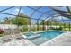 Luxury screened pool and spa with lounge chairs at 5252 Willow Lake Ct, Sarasota, FL 34233