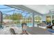 Covered patio with dining table and stunning pool view at 5252 Willow Lake Ct, Sarasota, FL 34233