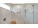 Spa-like shower with marble wall tiles and a built-in seat at 5252 Willow Lake Ct, Sarasota, FL 34233
