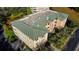 Aerial view of building showcasing roofline, landscaping and parking at 5306 Manorwood Dr # 2A, Sarasota, FL 34235