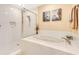 Bathroom with shower and bathtub, featuring white tile at 5306 Manorwood Dr # 2A, Sarasota, FL 34235
