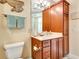 Bathroom with single vanity, toilet and linen storage at 5306 Manorwood Dr # 2A, Sarasota, FL 34235