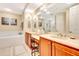 Double vanity bathroom with a large mirror and wood cabinets at 5306 Manorwood Dr # 2A, Sarasota, FL 34235