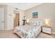 Bright bedroom featuring a queen-size bed and ensuite bathroom access at 5306 Manorwood Dr # 2A, Sarasota, FL 34235