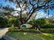 Gated entrance to Grand Oak community with lush landscaping and a welcoming sign at 5306 Manorwood Dr # 2A, Sarasota, FL 34235