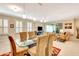Bright dining area with glass table and seating for six at 5306 Manorwood Dr # 2A, Sarasota, FL 34235