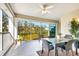 Relaxing enclosed patio with outdoor dining furniture and scenic view at 5306 Manorwood Dr # 2A, Sarasota, FL 34235