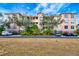 Three-story building exterior with light peach walls and dark roofing at 5306 Manorwood Dr # 2A, Sarasota, FL 34235